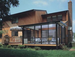 a studio style sunroom on exterior of home