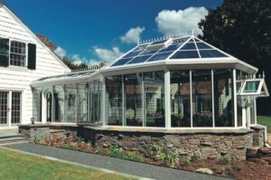 a beautiful sunroom addition with a solarium roof
